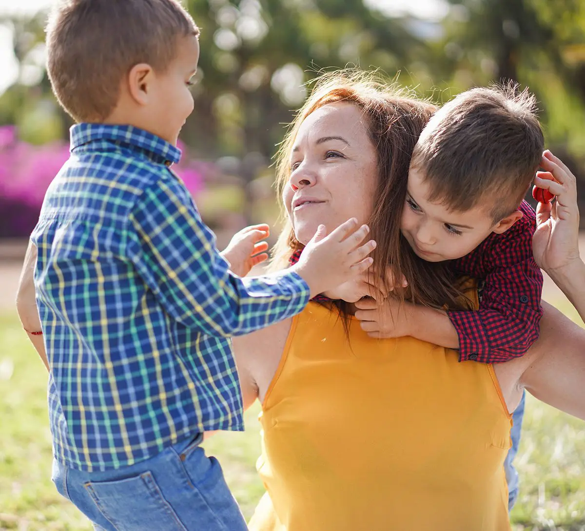 Mother have playful time with twin sons in nature park - Family, single mother and children love