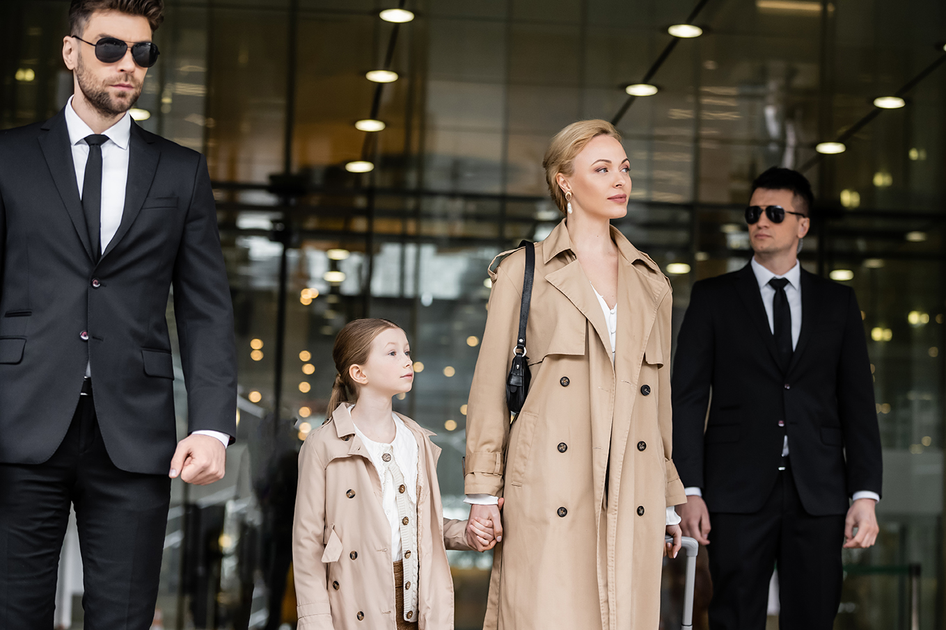 bodyguards walking next to blonde successful woman and preteen kid, entering hotel, private security, mother and daughter in trench coats, safety and protection, family travel, rich life